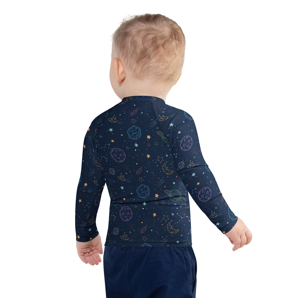 Navy blue long-sleeved baby rash guard swim shirt with pastel space-themed print and UPF 50 for sun protection