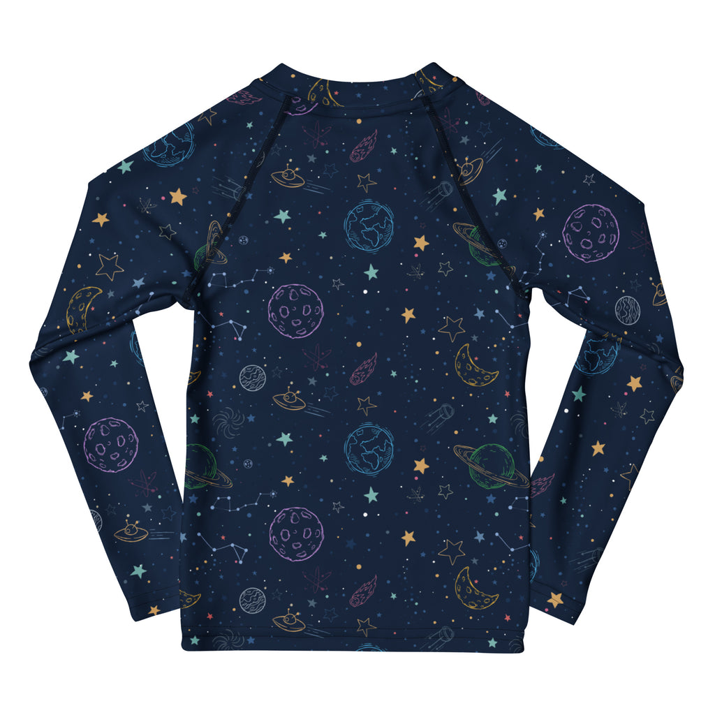 Dark blue long sleeve rash guard with playful pastel space print featuring planets stars moons ufos and UPF 50+ protection