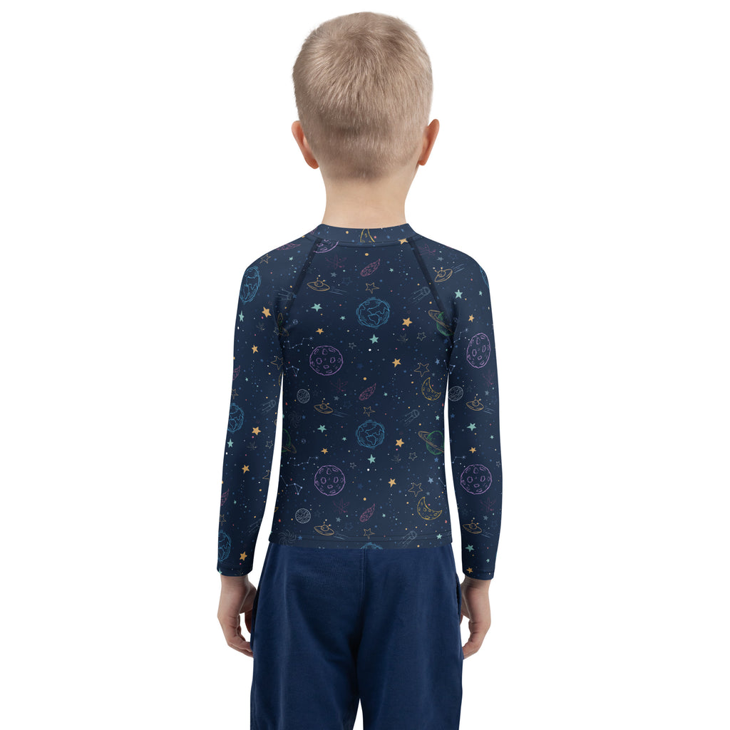 A navy blue long-sleeved rash guard swim shirt with playful pastel space-themed print and UPF 50 plus protection