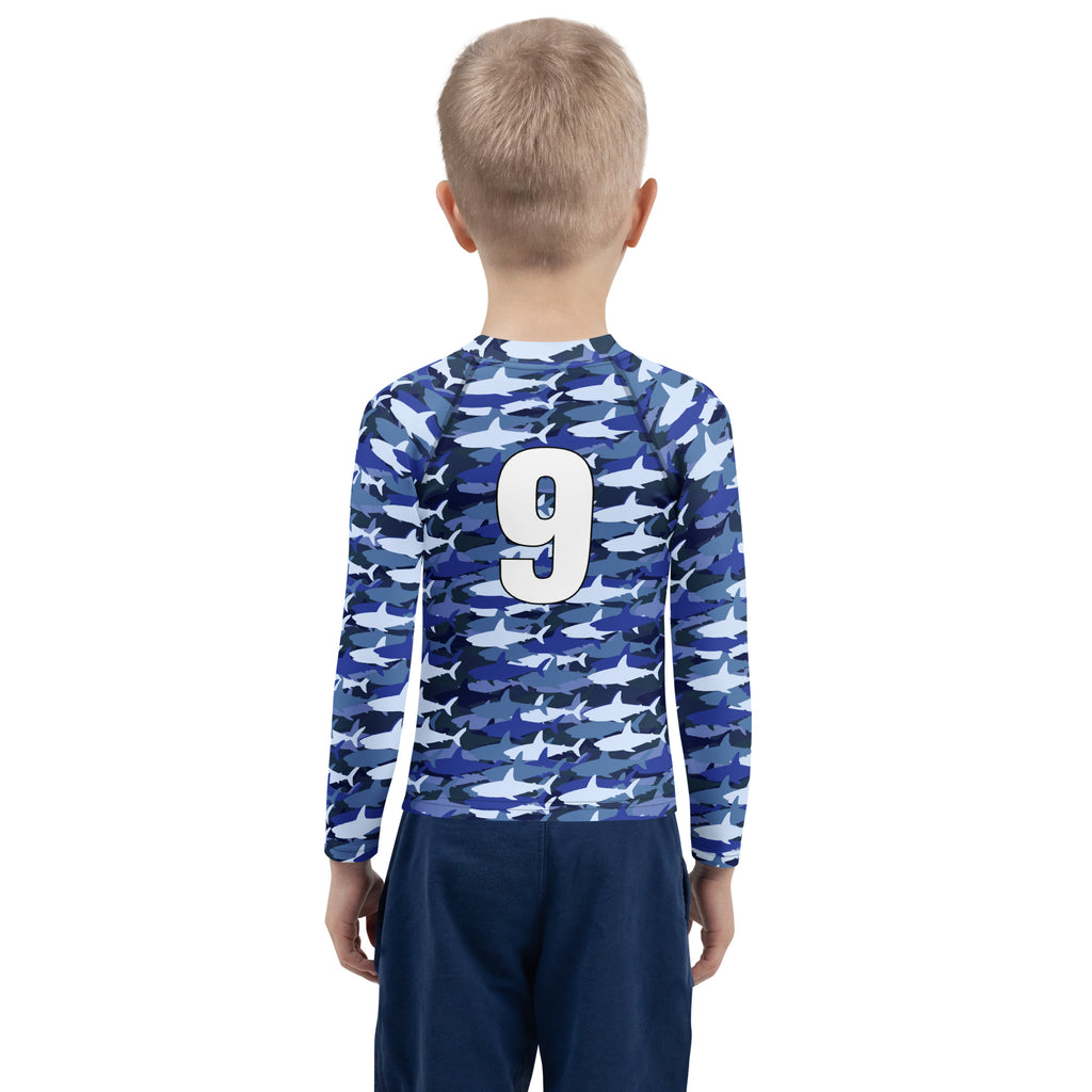 Back view of custom birthday boy blue long-sleeved shark rash guard with camouflage pattern and number 9 in white