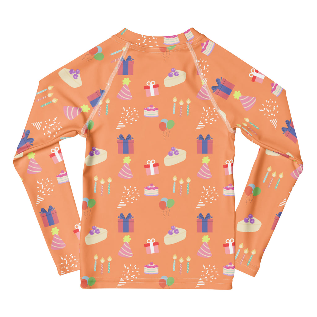 Orange long sleeve rash guard with upf 50 featuring birthday boy pattern of cakes gifts and party hats for swim use