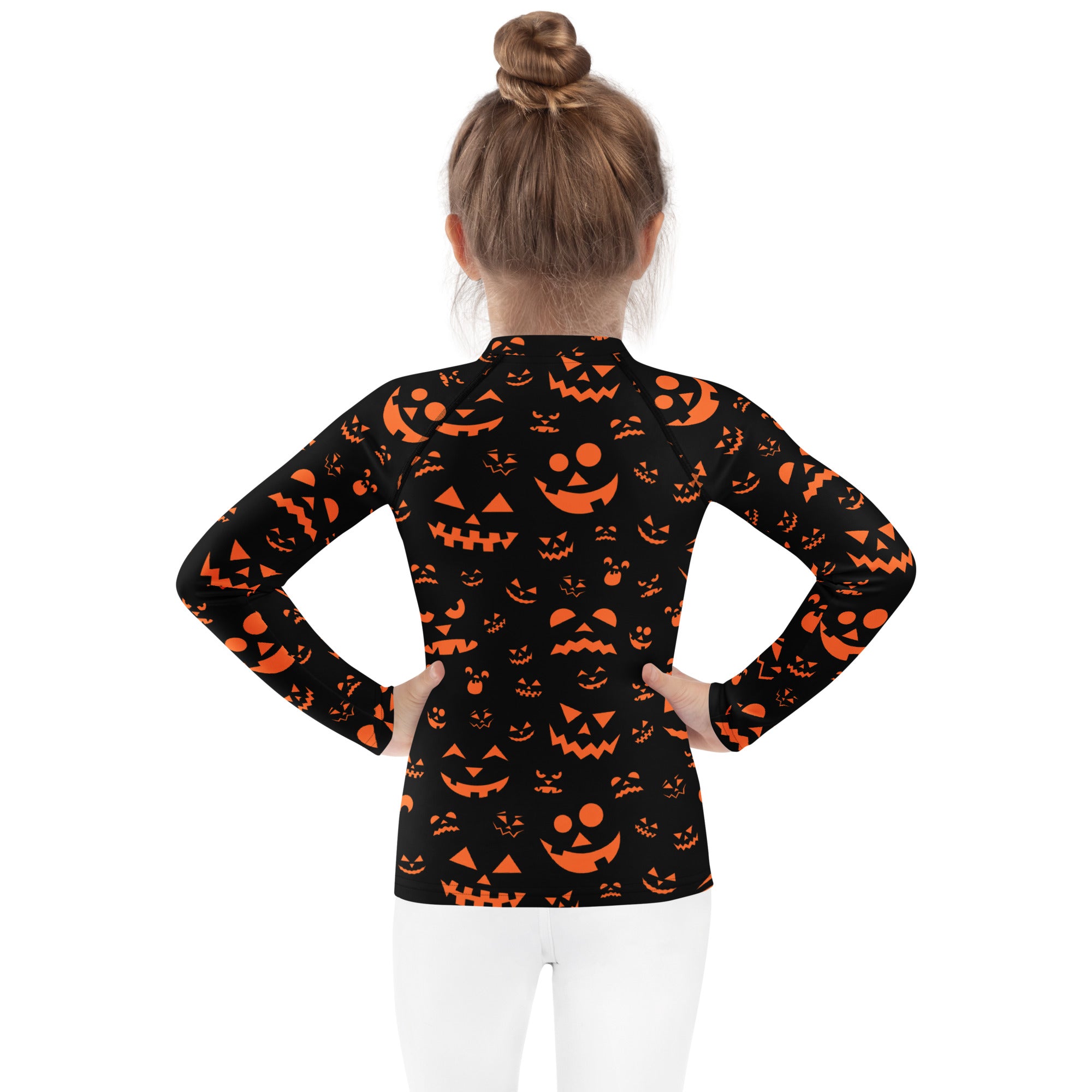 Kids black long sleeve halloween rash guard swim shirt with orange jack o lantern faces and upf 50 plus protection