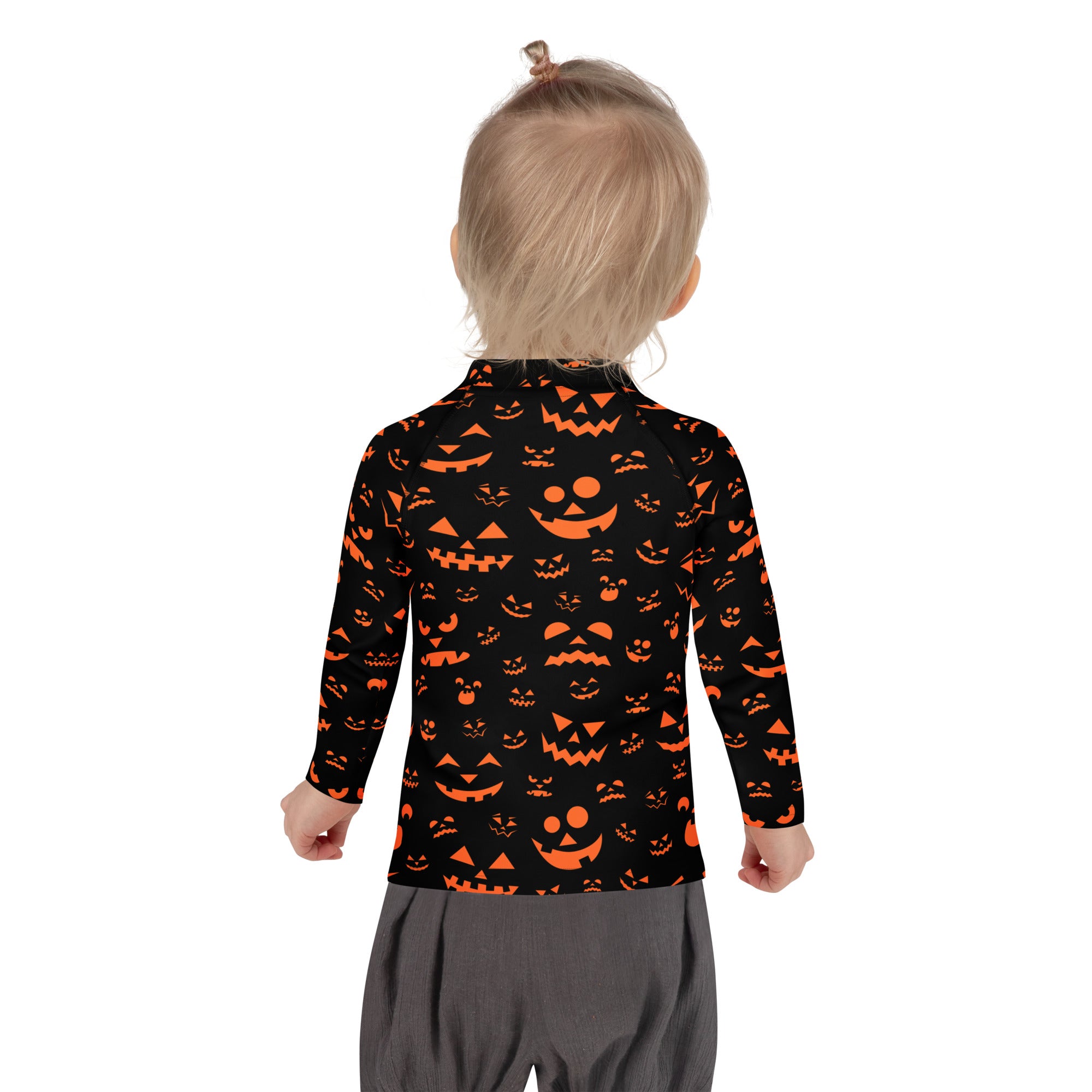 Black long-sleeved rash guard swim shirt with orange jack-o-lantern faces and upf 50+ for kids halloween use