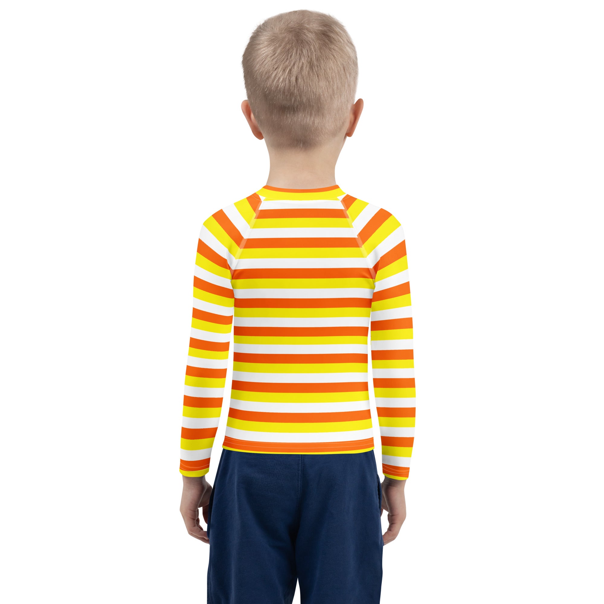 A child wearing a kids candy corn stripes halloween long sleeve rash guard swim shirt with upf 50 plus in orange yellow and white