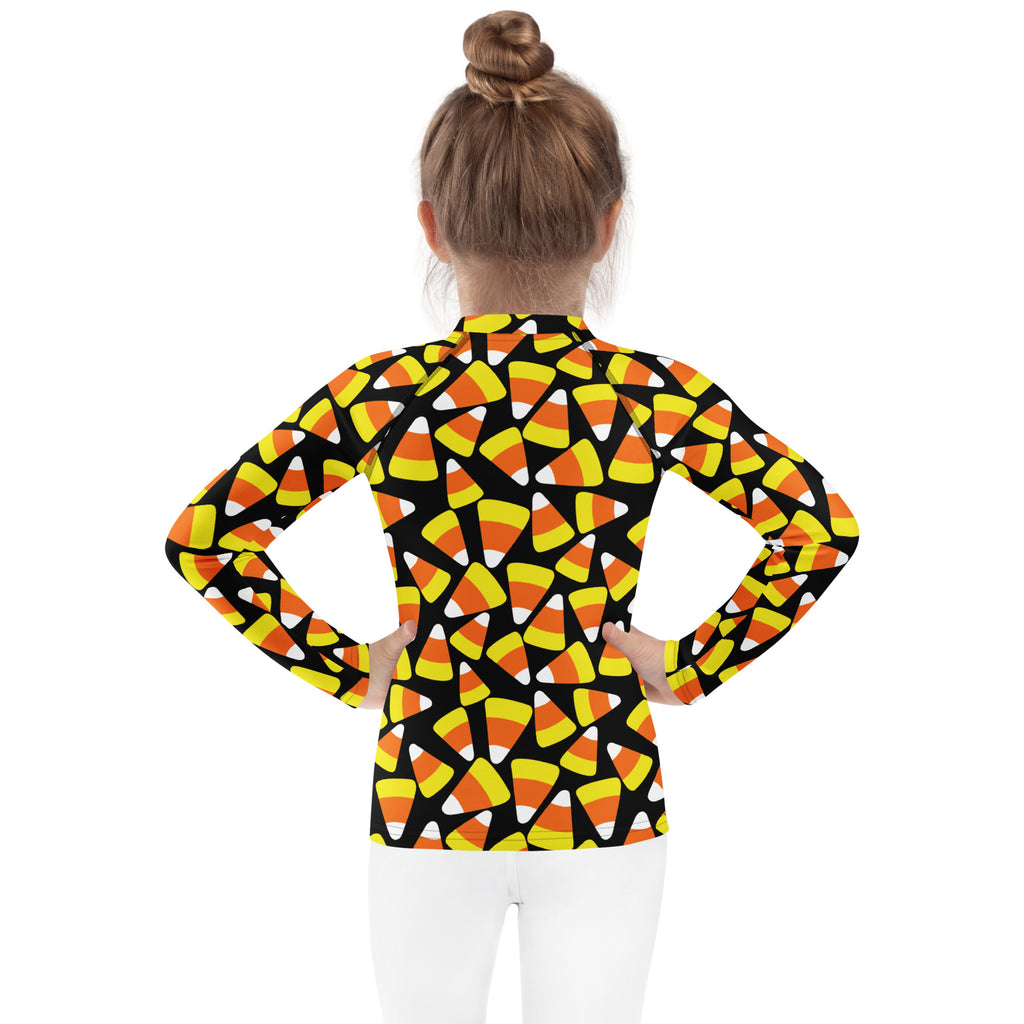 Kids candy corn halloween long sleeve rash guard swim shirt with upf 50 plus featuring black base with vibrant candy corn pattern