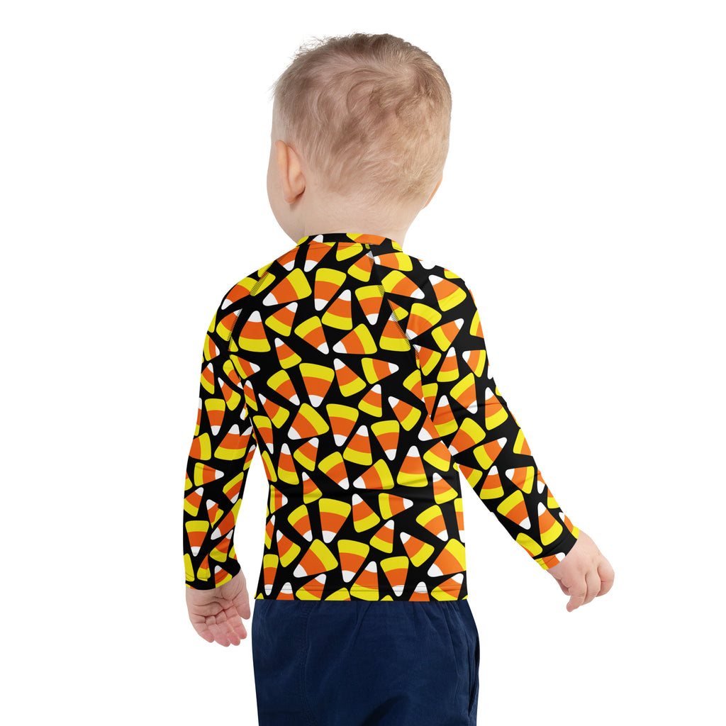 Kids candy corn halloween long sleeve rash guard swim shirt with upf 50 plus featuring vibrant candy corn pattern on black