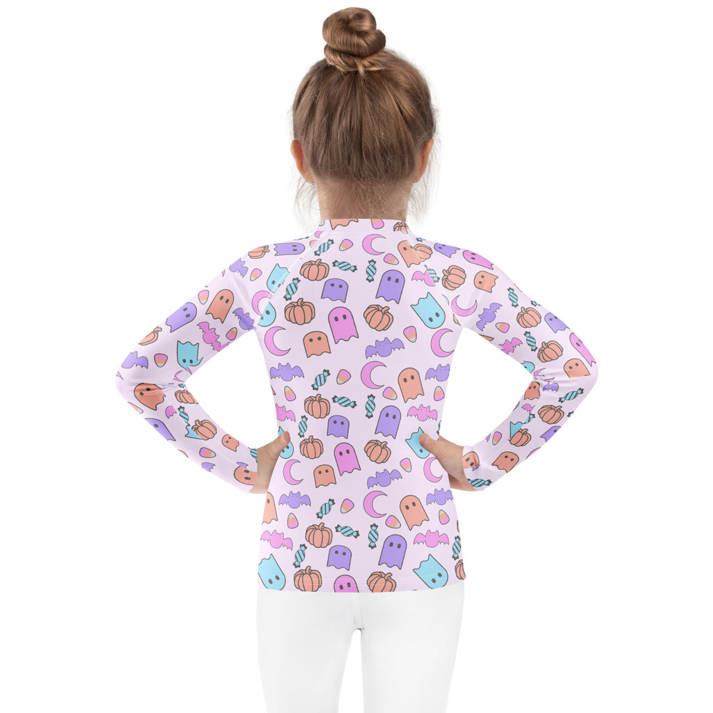Girls halloween pattern long sleeve rash guard swim shirt in light purple with pastel ghosts pumpkins bats and candy design