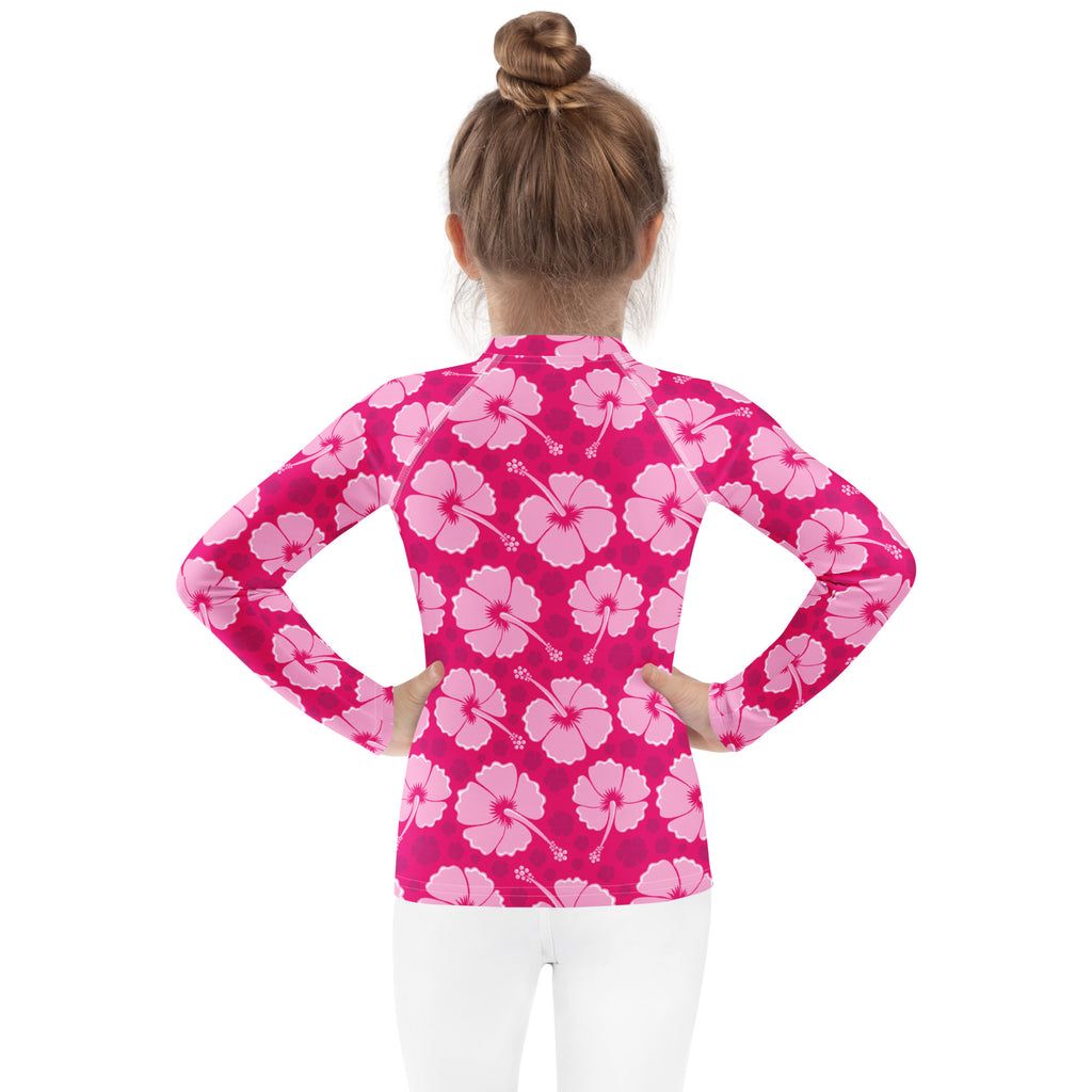 Girls tropical pink hibiscus long sleeve rash guard swim shirt with UPF 50 plus featuring a floral pattern