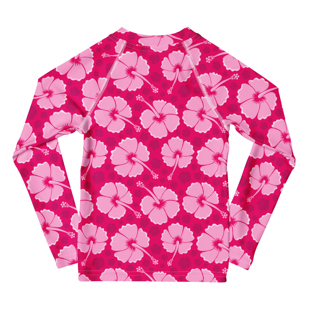 Girls tropical pink hibiscus long sleeve rash guard swim shirt with UPF 50 plus featuring a floral pattern