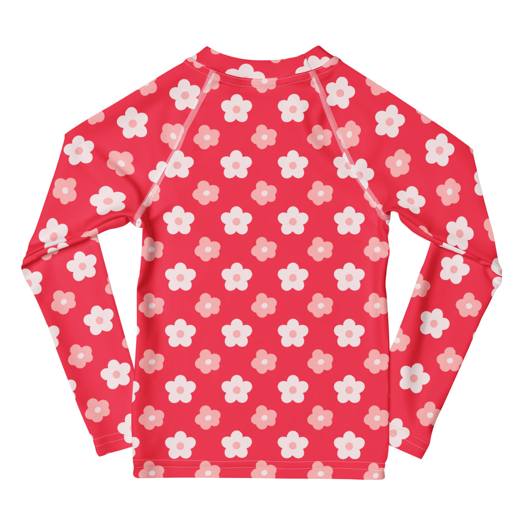 A vibrant red girls long sleeve rash guard swim shirt with white and light pink floral pattern and upf 50+ protection