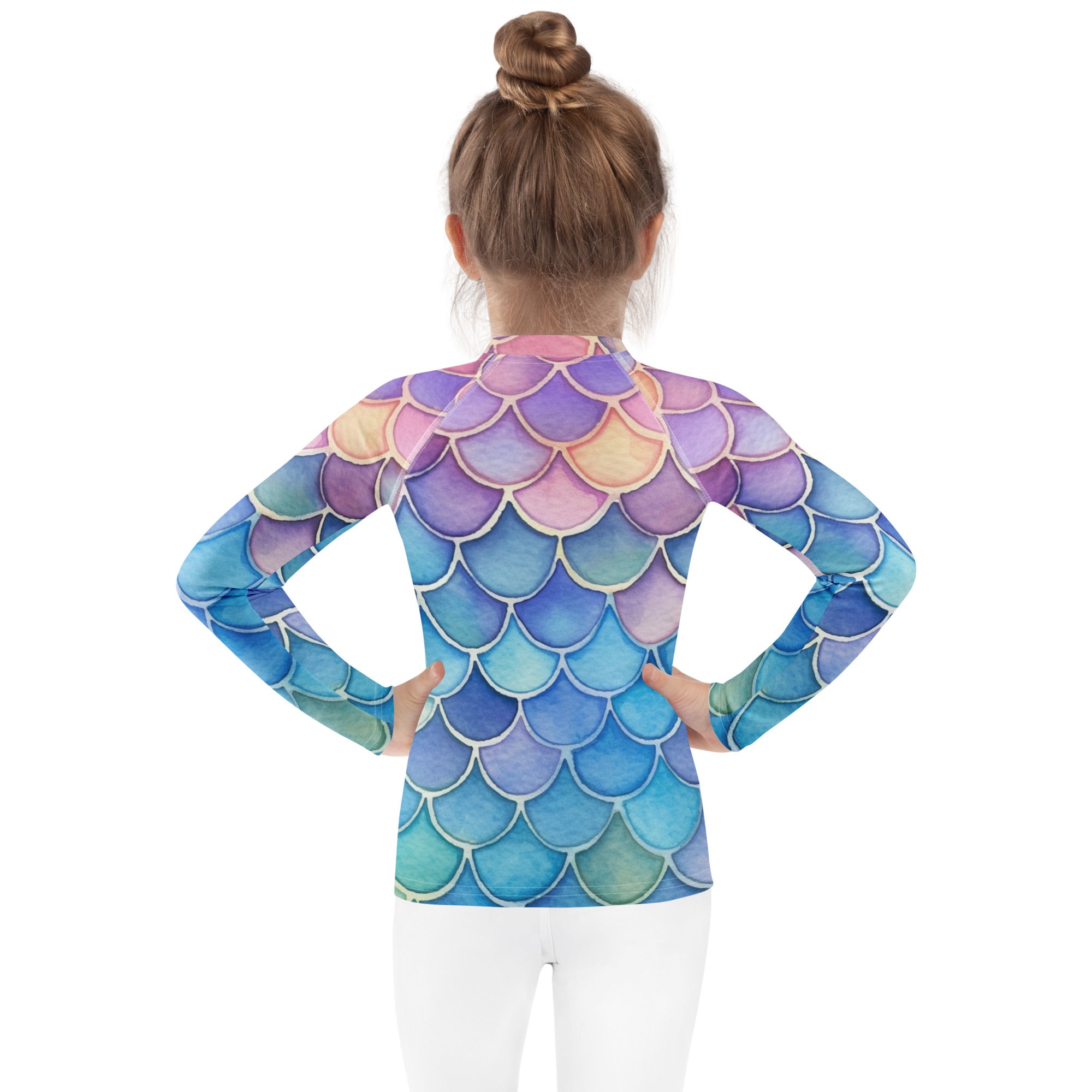 A child wearing a girls watercolor rainbow mermaid long sleeve rash guard swim shirt with upf 50+ in blue purple and pink