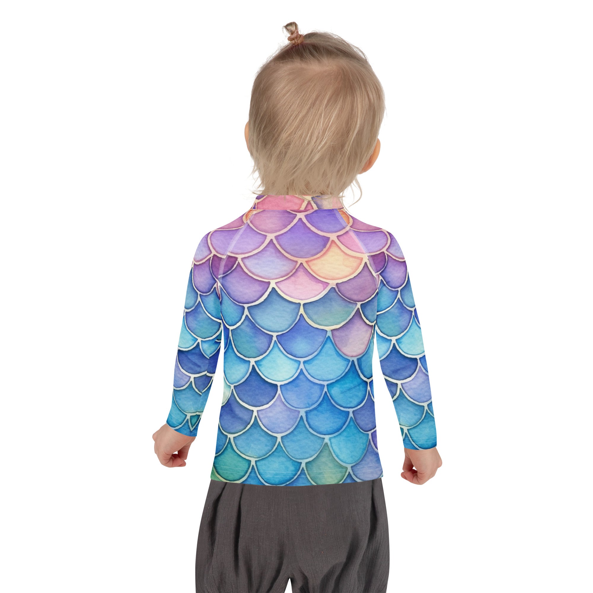 A child wearing a girls watercolor rainbow mermaid long sleeve rash guard in purple blue and pink with UPF 50+ protection