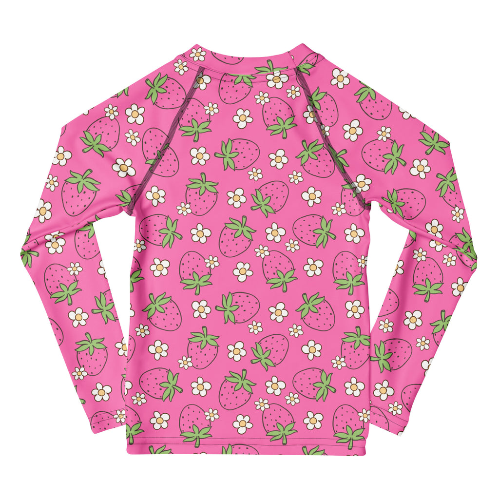 Girls pink long sleeve rash guard swim shirt with upf 50 plus featuring playful strawberry and white flower pattern