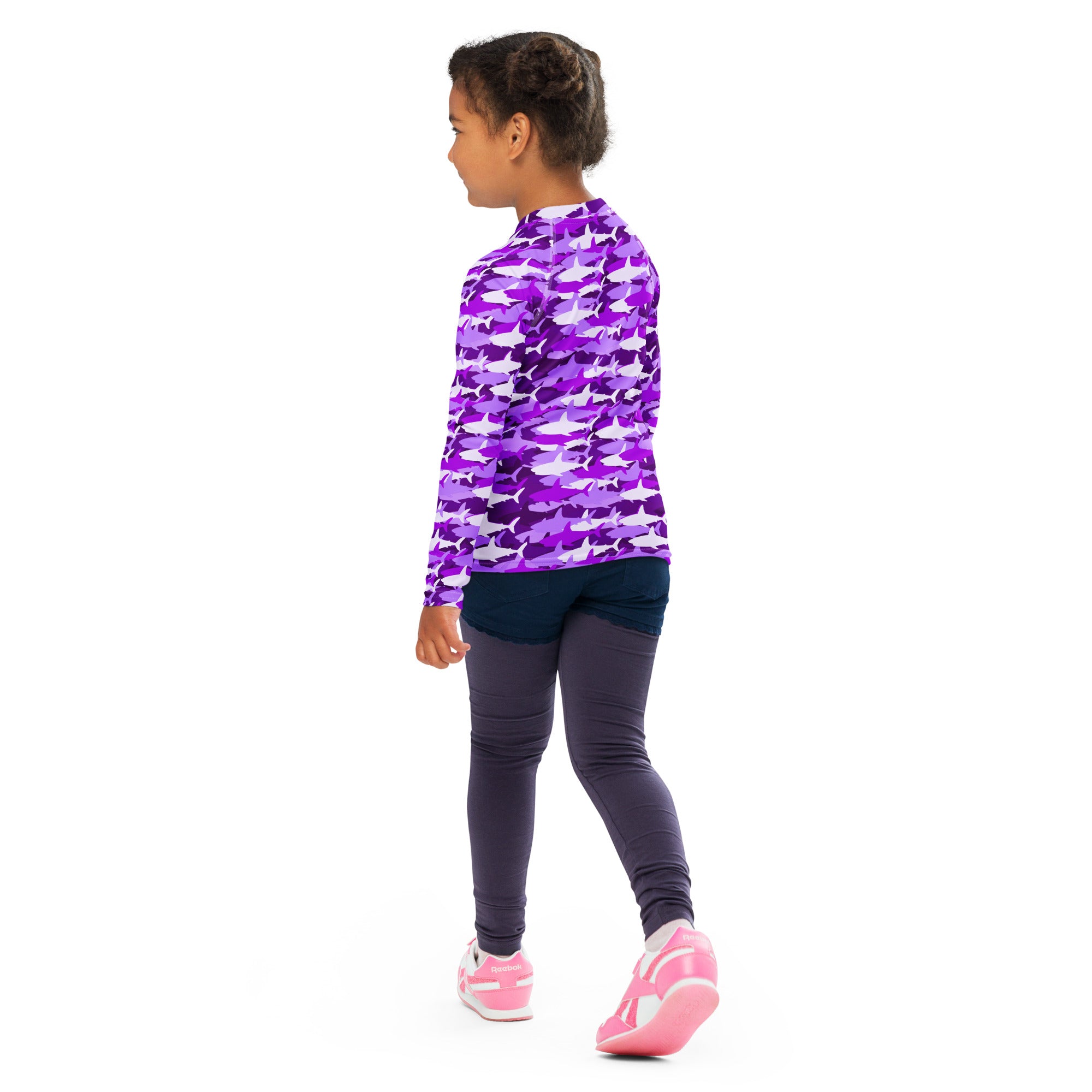 Girls purple long sleeve rash guard swim shirt with upf 50 plus featuring a repeating shark pattern in varying shades of purple and white