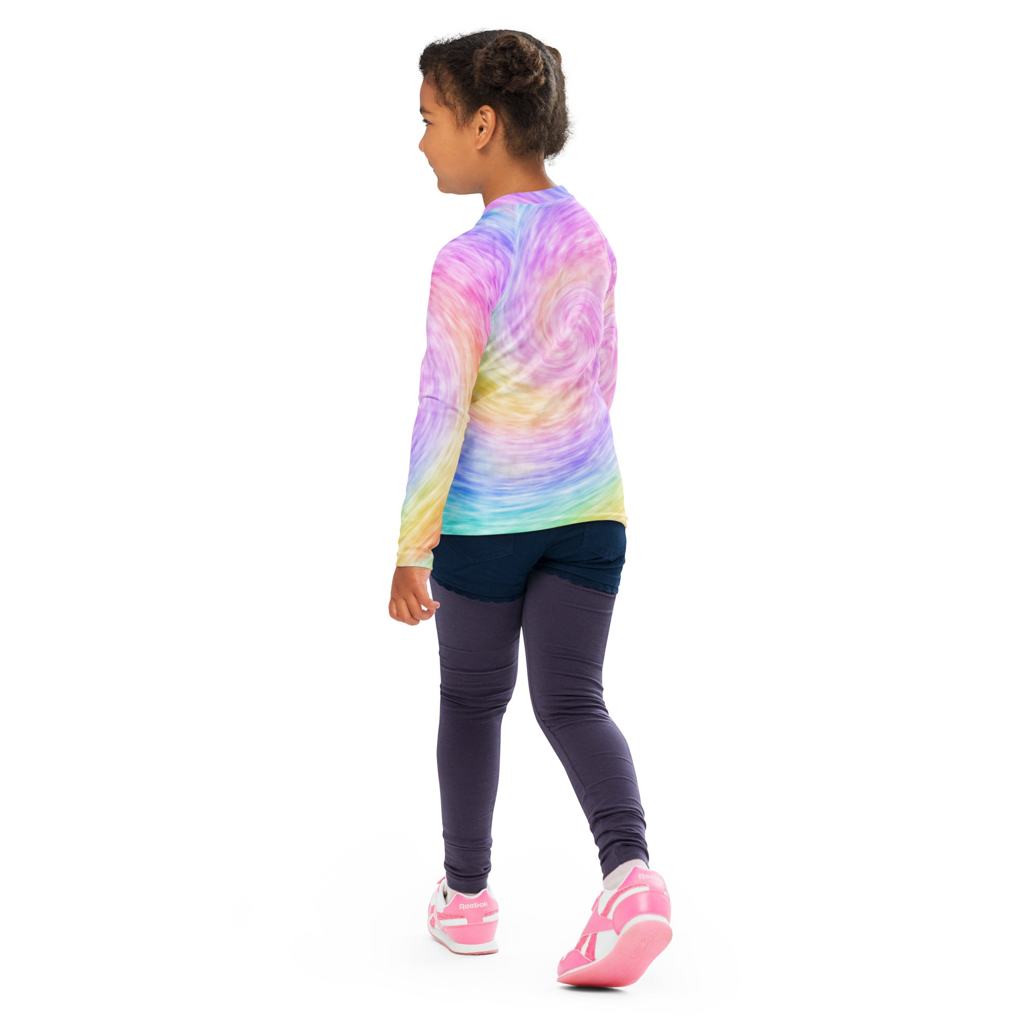A child wearing a girls faux rainbow tie dye long sleeve rash guard swim shirt with upf 50 plus and navy leggings