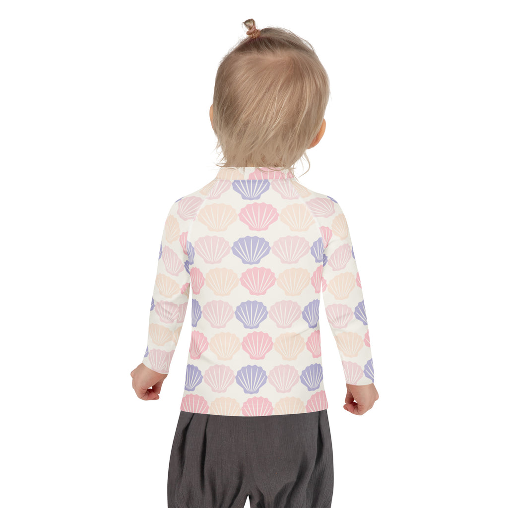 Kids seashell print long sleeve rash guard swim shirt with upf 50plus featuring pastel pink lavender and cream seashells