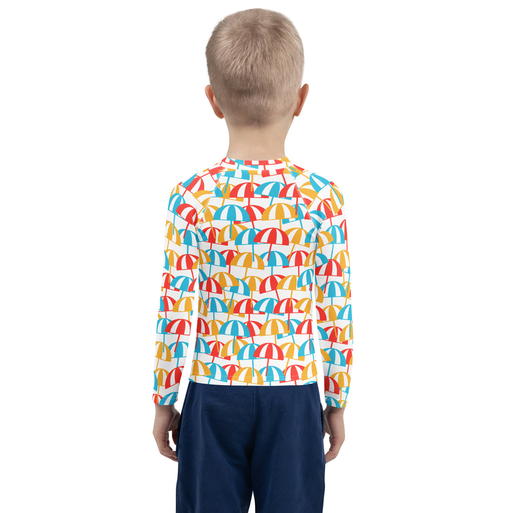 A child wearing a kids beach umbrella long sleeve rash guard swim shirt with upf 50 and colorful umbrella pattern
