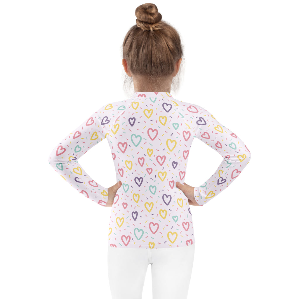 Girls hearts and sprinkles long sleeve rash guard swim shirt in white with multicolored heart pattern and UPF 50+ protection