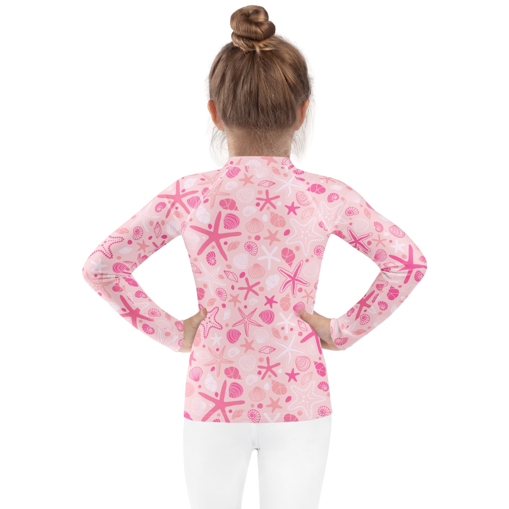 Girls pink starfish and seashell long sleeve rash guard swim shirt with UPF 50 plus featuring pink pattern