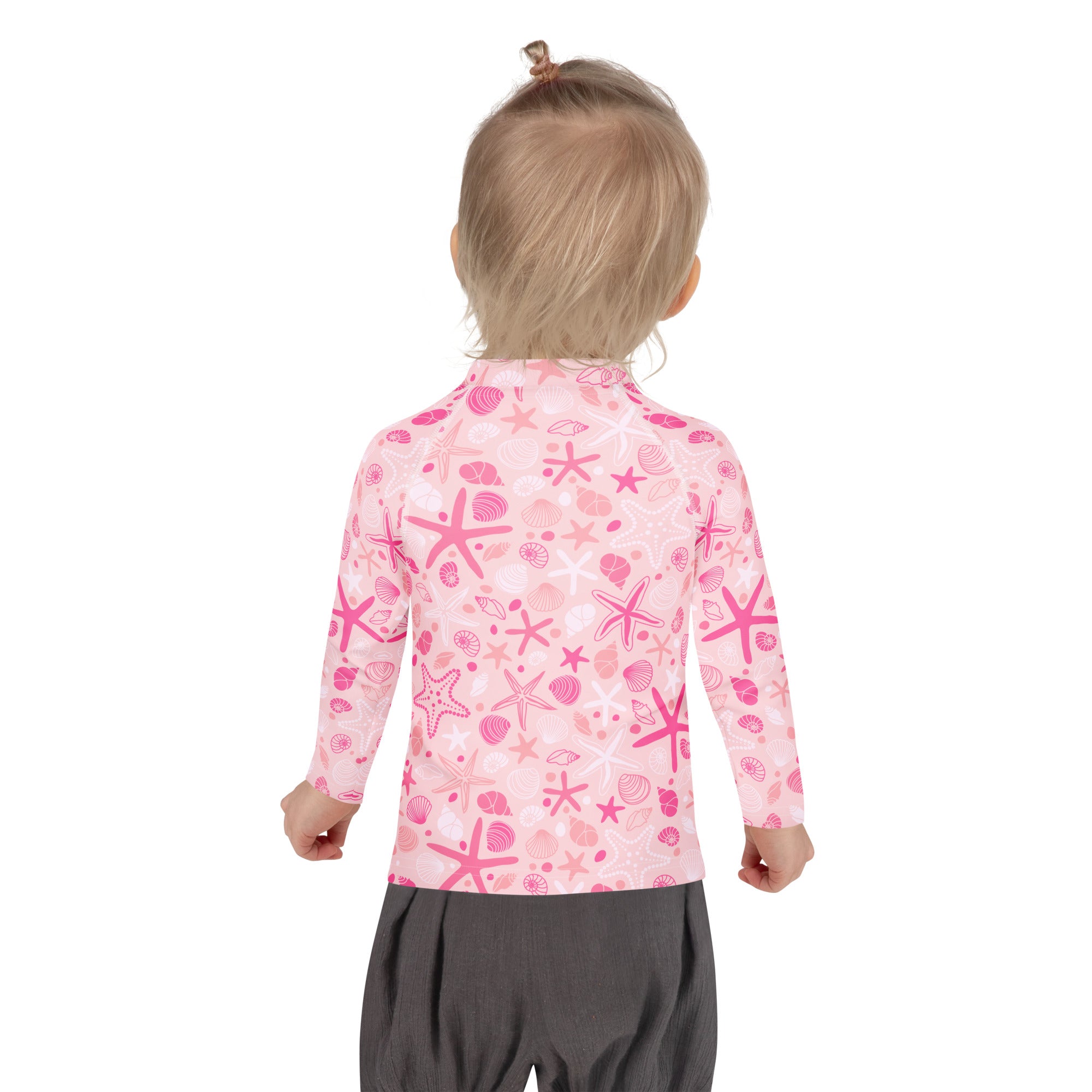 Girls pink long sleeve rash guard swim shirt with upf 50 and playful sea-themed starfish and seashell pattern