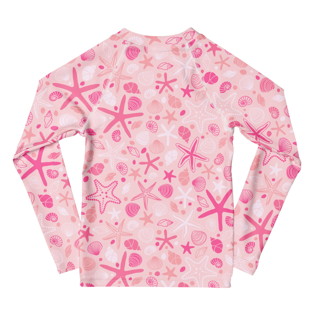 Girls pink starfish and seashell long sleeve rash guard swim shirt with playful pattern and upf 50 plus protection