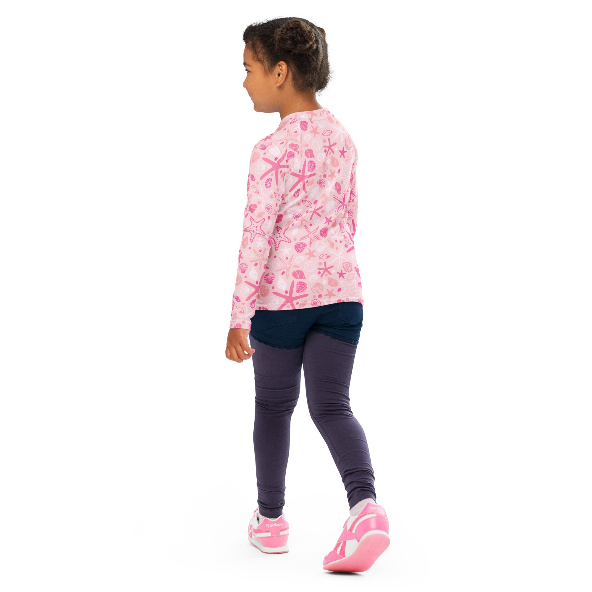 Girls pink long sleeve rash guard swim shirt with starfish and seashell patterns and upf 50 plus protection