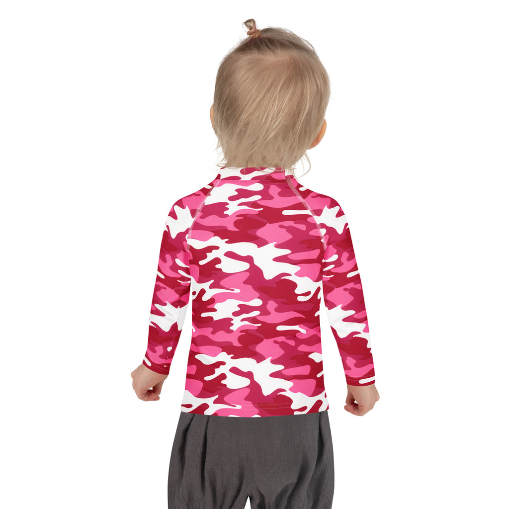 A child wearing a girls pink camouflage long sleeve rash guard swim shirt with UPF 50 plus for sun protection