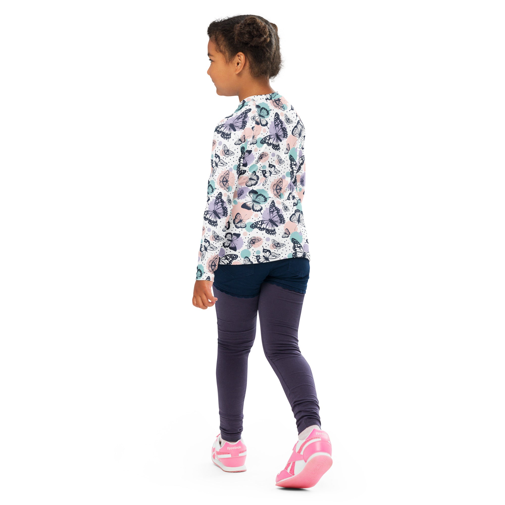 A child wearing a girls butterfly long sleeve rash guard swim shirt with upf 50 plus in pink teal and black butterfly print