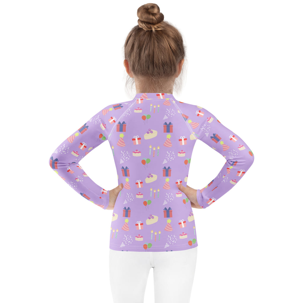 Girls purple long sleeve rash guard swim shirt with UPF 50 plus featuring birthday cake and gift pattern