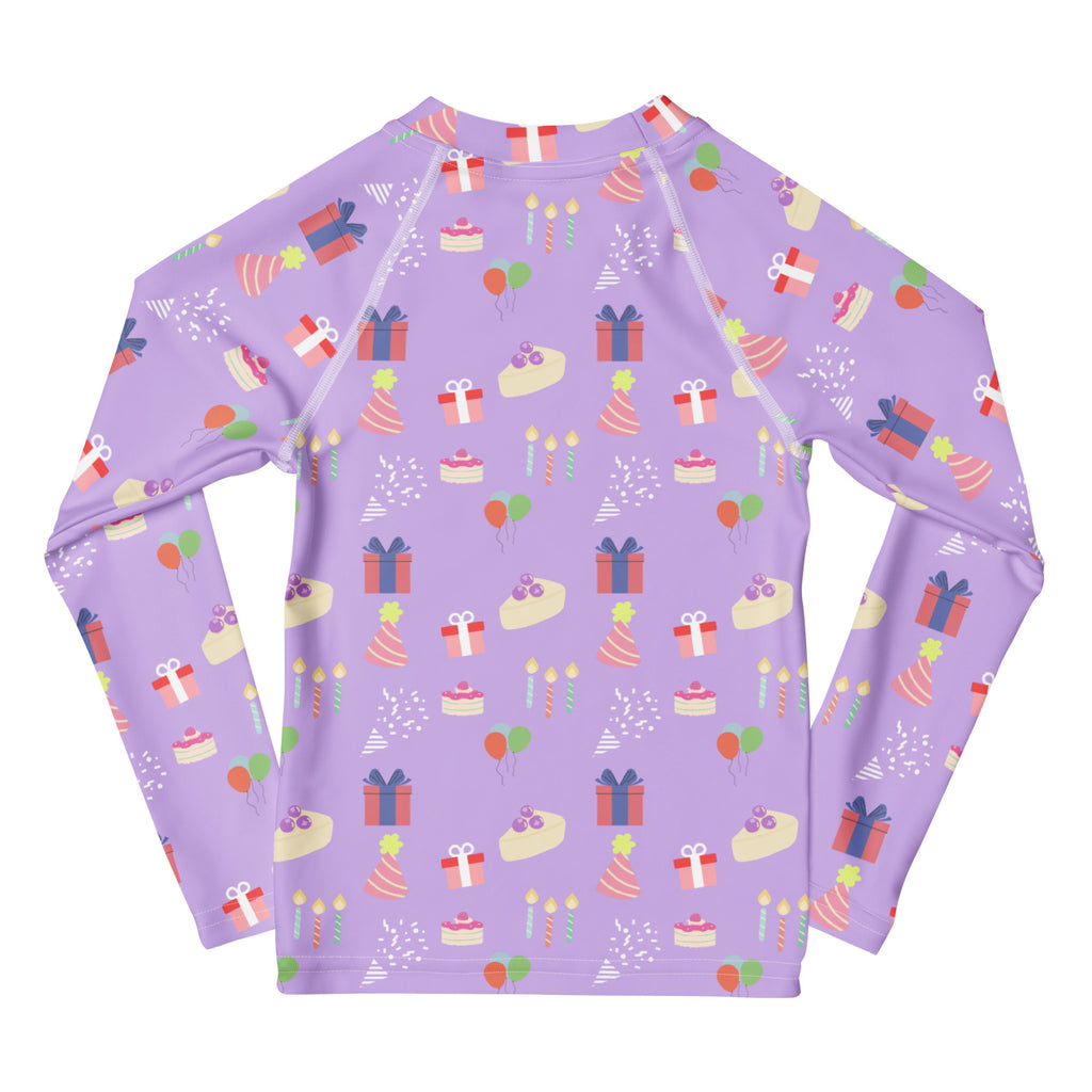 Girls purple long sleeve rash guard swim shirt with birthday pattern cakes presents hats candles and UPF 50 plus protection