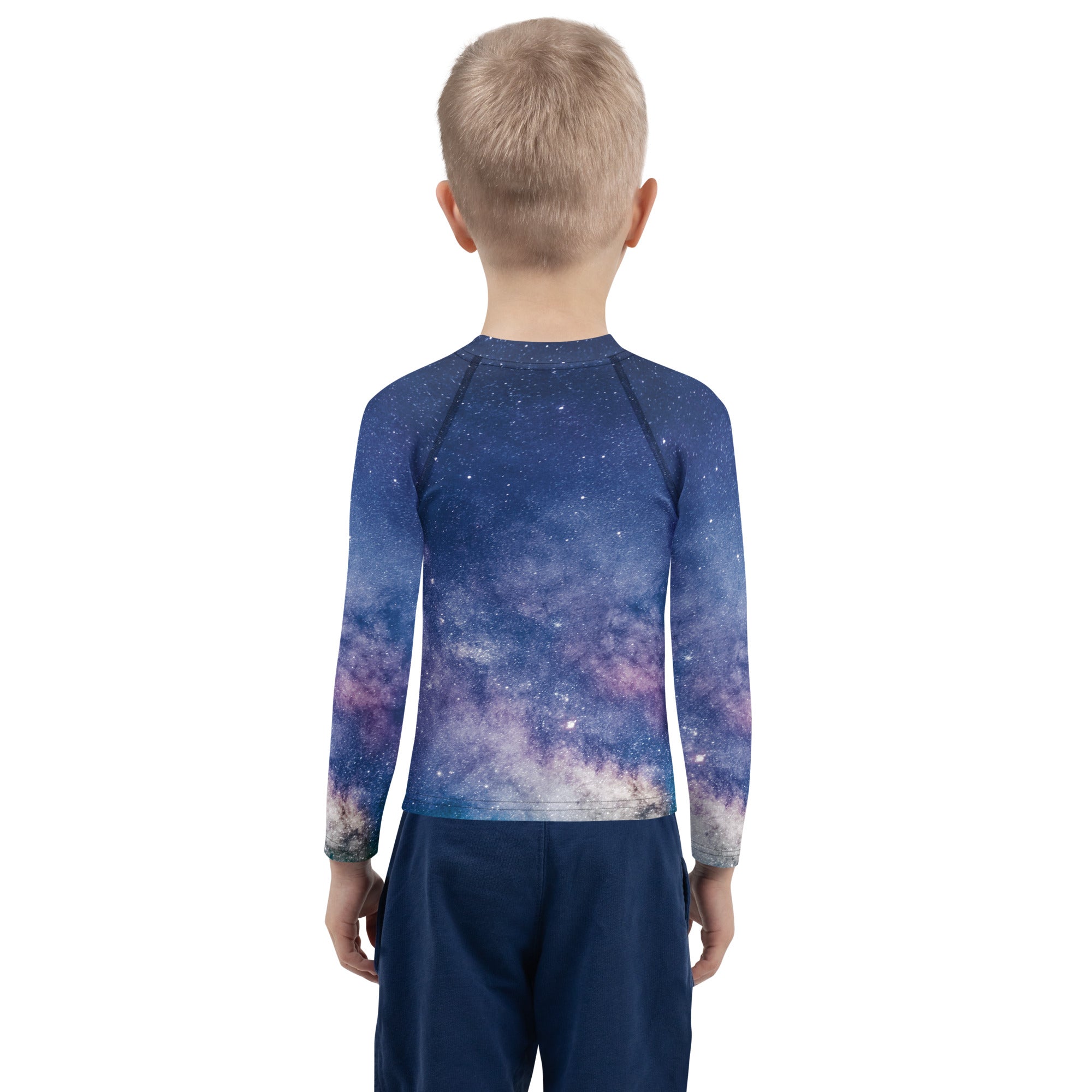 A child wearing a kids realistic galaxy long sleeve rash guard swim shirt with UPF 50+ in deep blue and purple stars