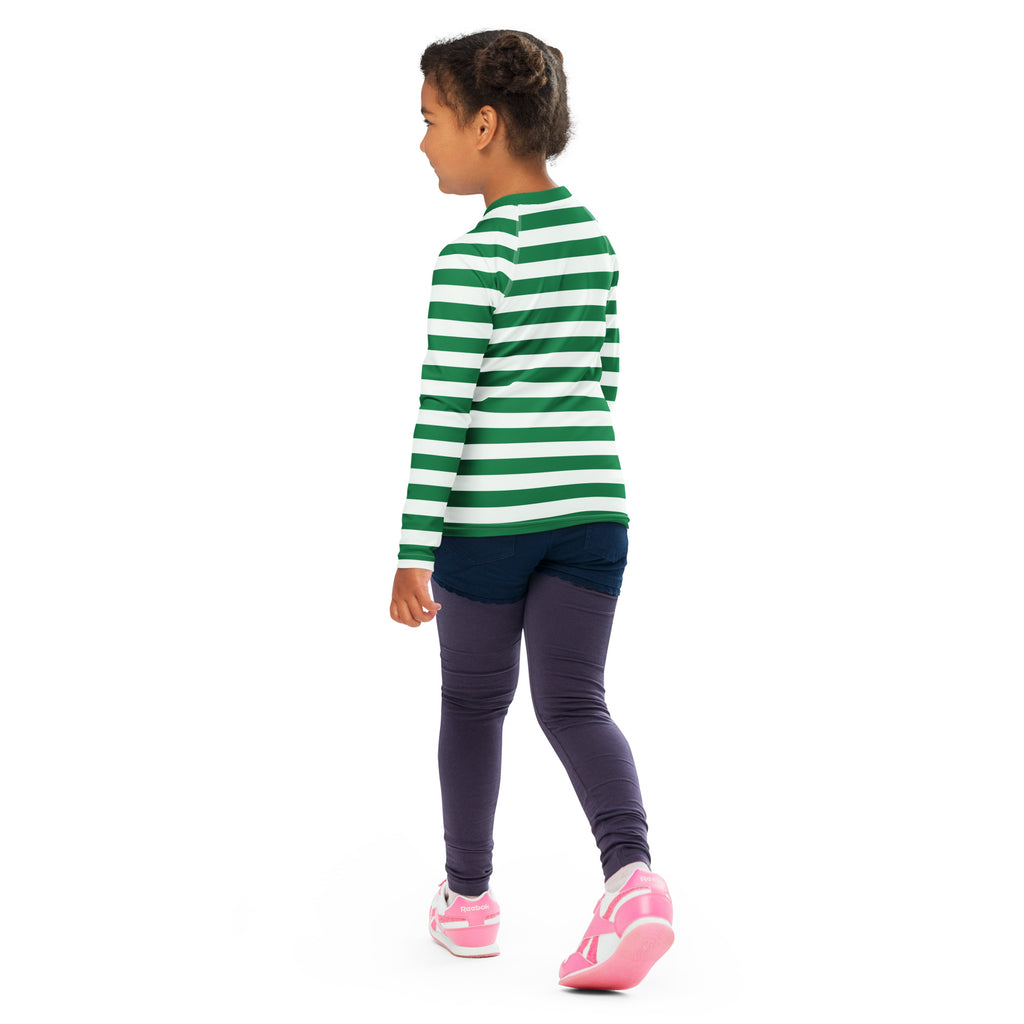 A child wearing a kids green and white striped Christmas long sleeve rash guard swim shirt with UPF 50 plus