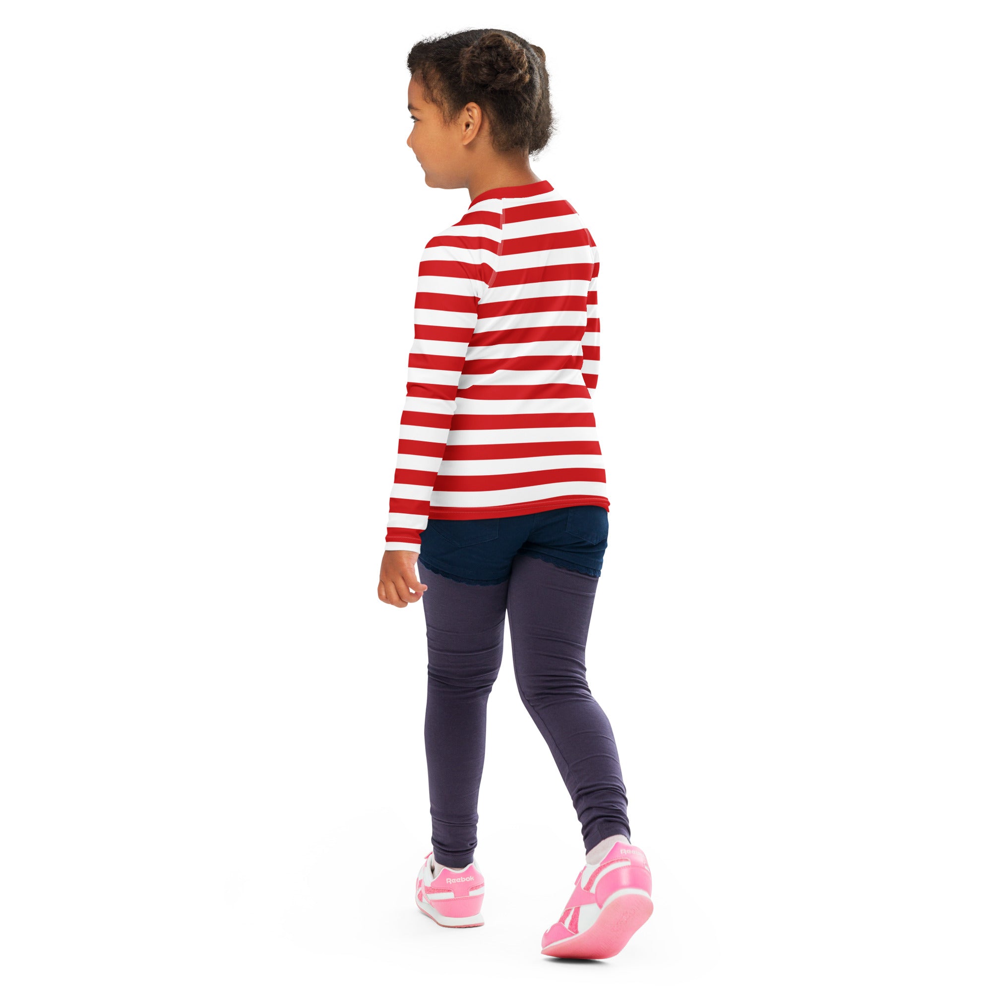 A child wearing a kids red and white striped long sleeve rash guard swim shirt with UPF 50+ and navy leggings