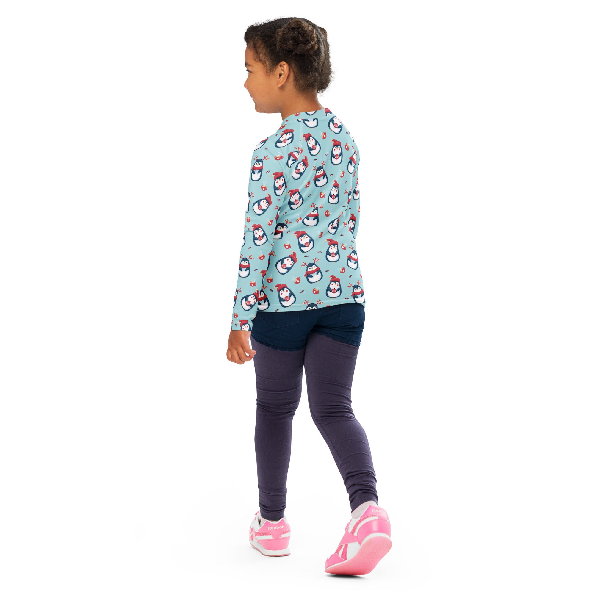 A child wearing a light blue kids reindeer penguin Christmas long sleeve rash guard swim shirt with UPF 50+