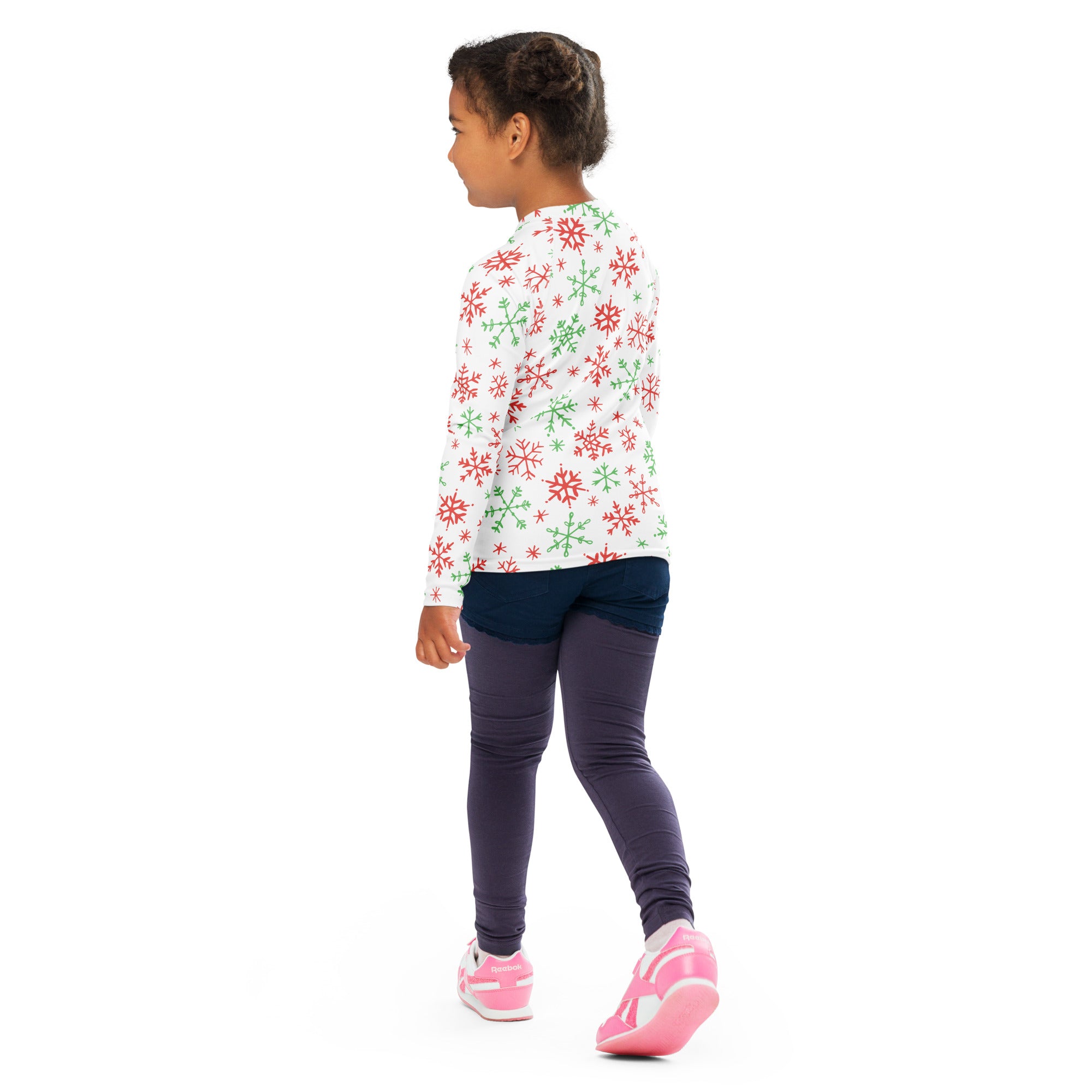 A child wearing a kids red and green snowflakes Christmas long sleeve rash guard swim shirt with upf 50 plus