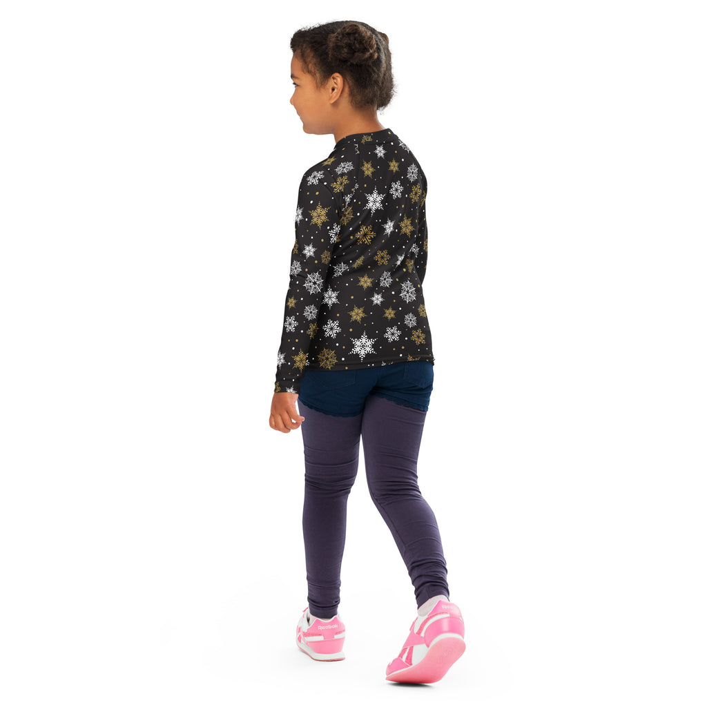 Black long-sleeved kids rash guard swim shirt with white and gold snowflake pattern and upf 50 plus protection