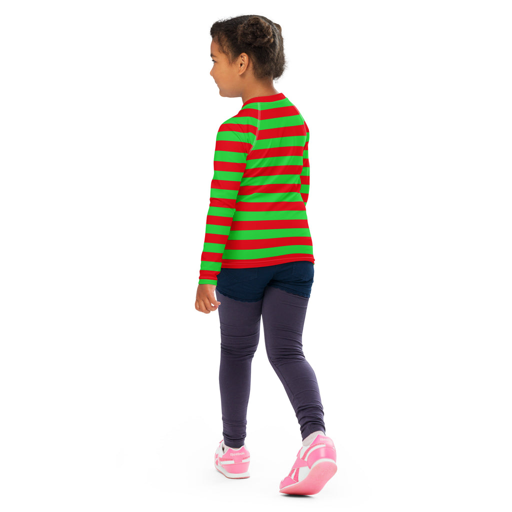A child wearing a kids red and green striped christmas long sleeve rash guard swim shirt with UPF 50+ protection