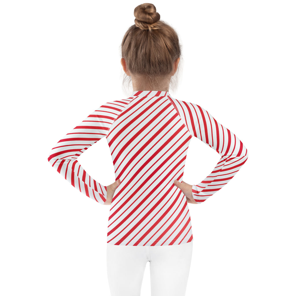 Kids red and white candy cane striped long sleeve rash guard swim shirt with upf 50 plus for sun protection
