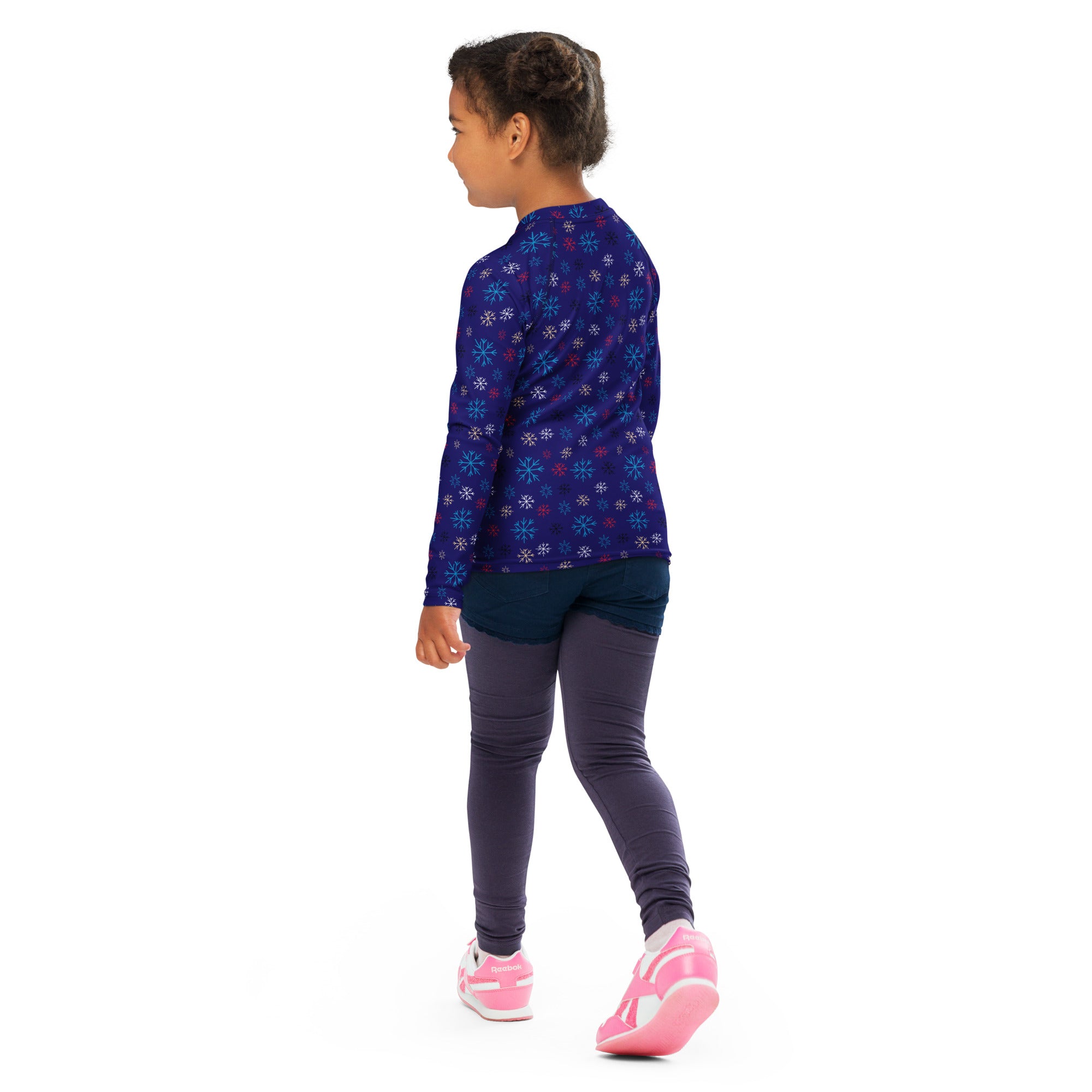 A child wearing a kids navy snowflake long sleeve rash guard swim shirt with upf 50 plus protection