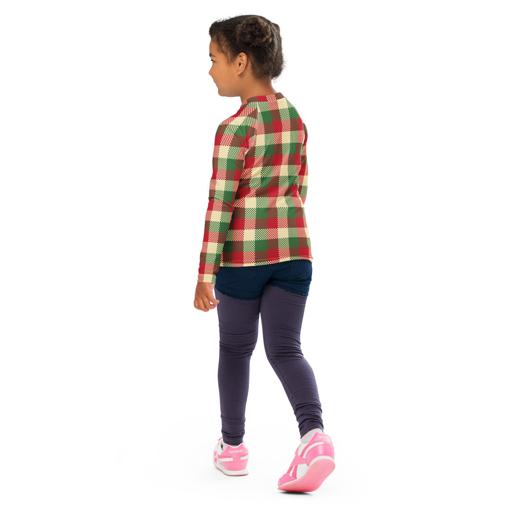 A child wearing a red green and cream plaid kids christmas rash guard swim shirt with UPF 50+ protection