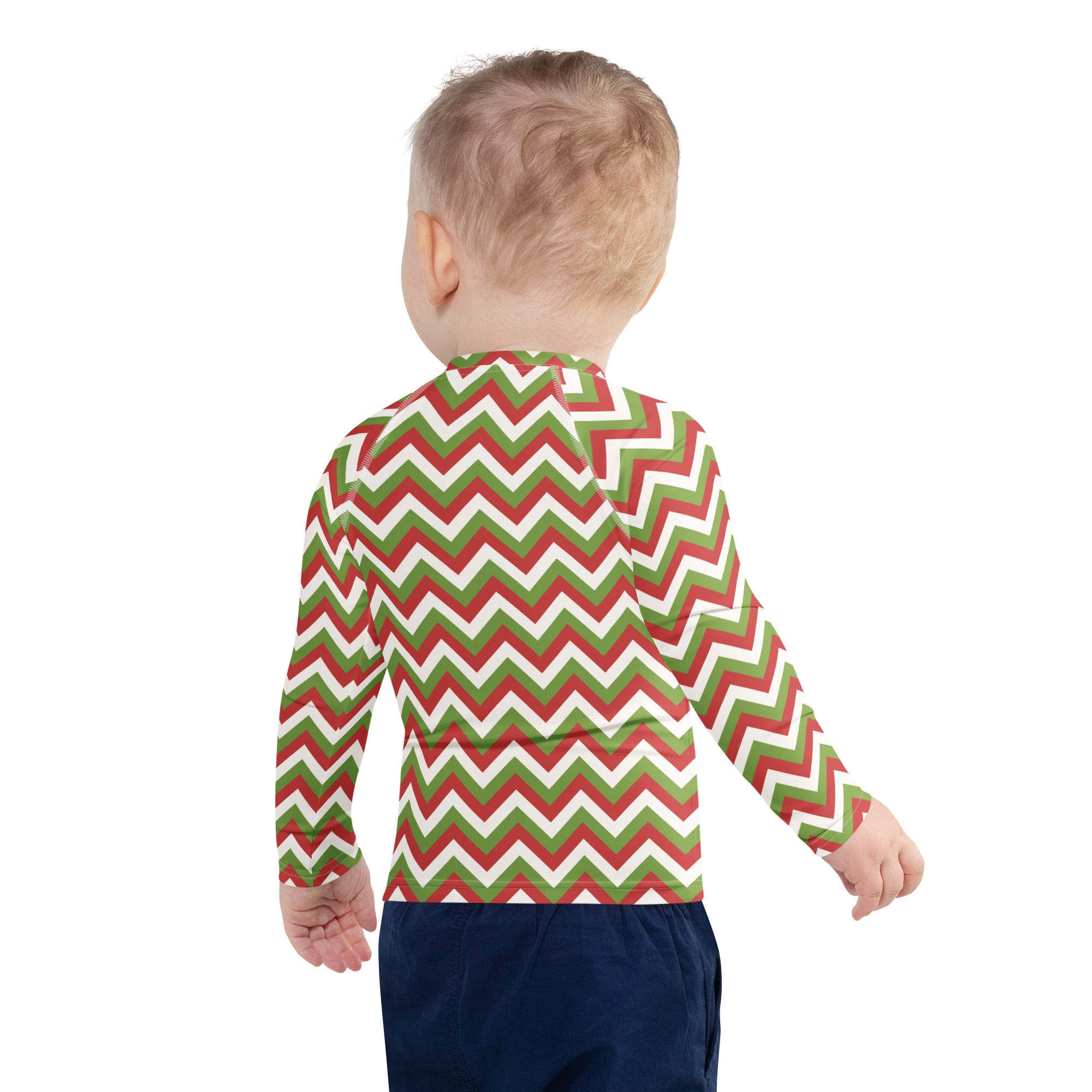 A child wearing a kids red and green chevron christmas long sleeve rash guard swim shirt with upf 50 plus