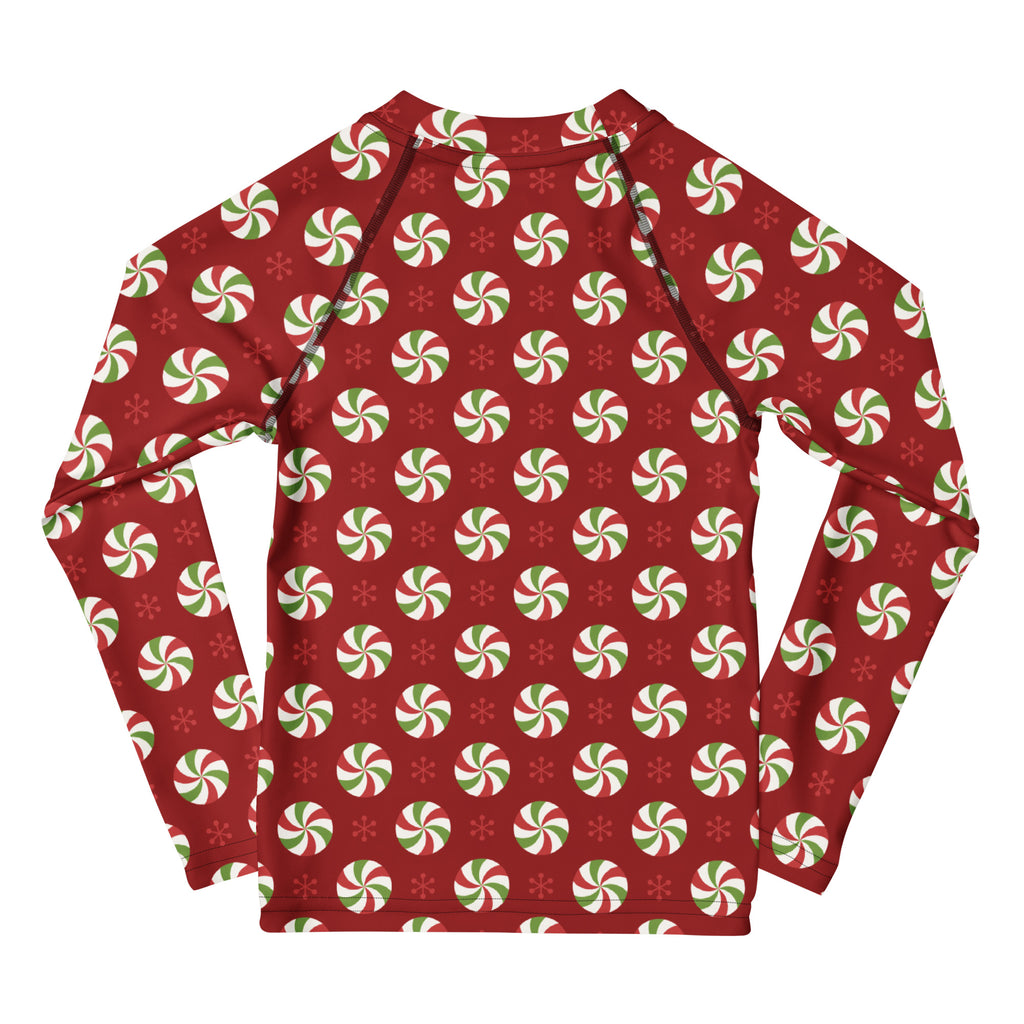 Red kids long sleeve rash guard with festive green and white peppermint candies and snowflakes, UPF 50 plus swim shirt
