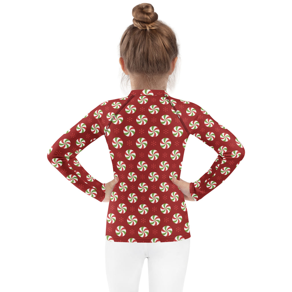Red long sleeve rash guard with festive green and white peppermint pattern kids swim shirt with upf 50+