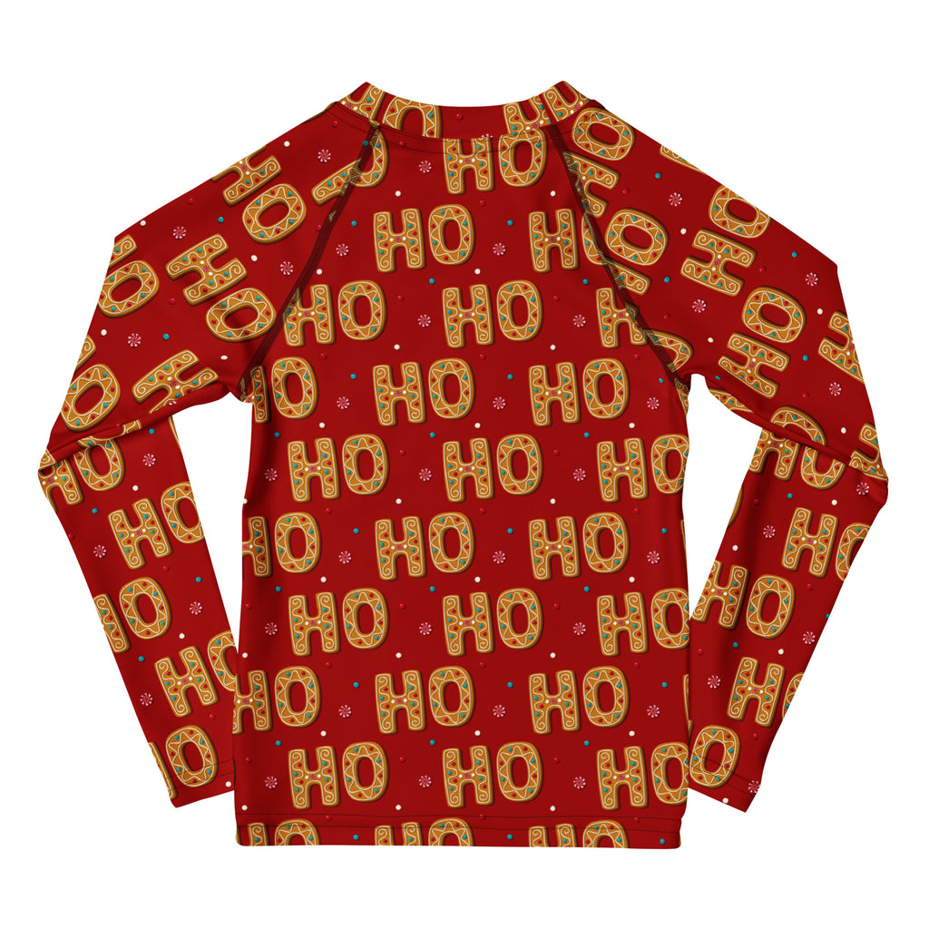 Kids red long sleeve rash guard with festive ho ho ho gingerbread pattern and snowflakes featuring UPF 50+ protection