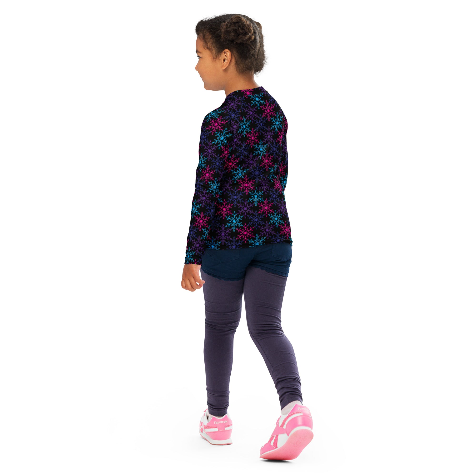 A child wearing a kids neon snowflakes christmas long sleeve rash guard swim shirt with upf 50 plus in dark colors