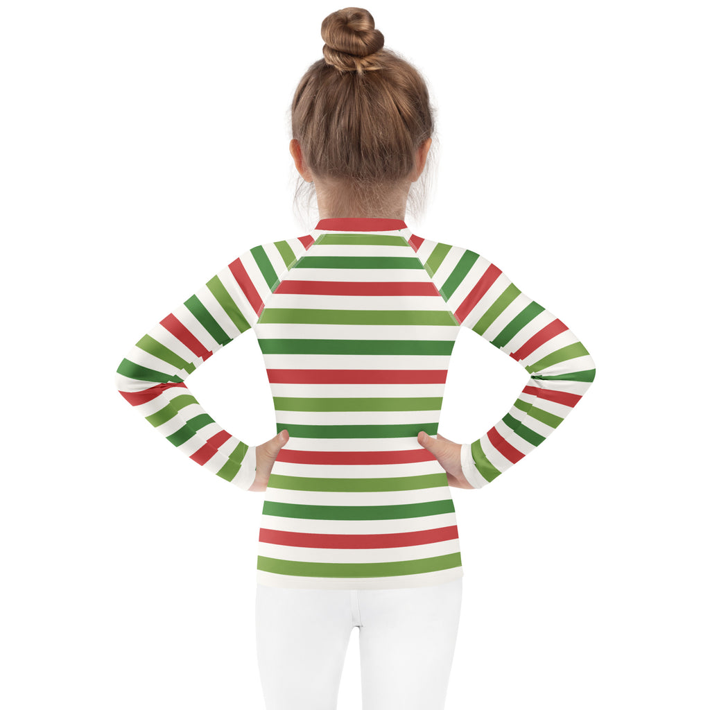 A child wearing a kids red and green christmas stripes long sleeve rash guard swim shirt with UPF 50 plus