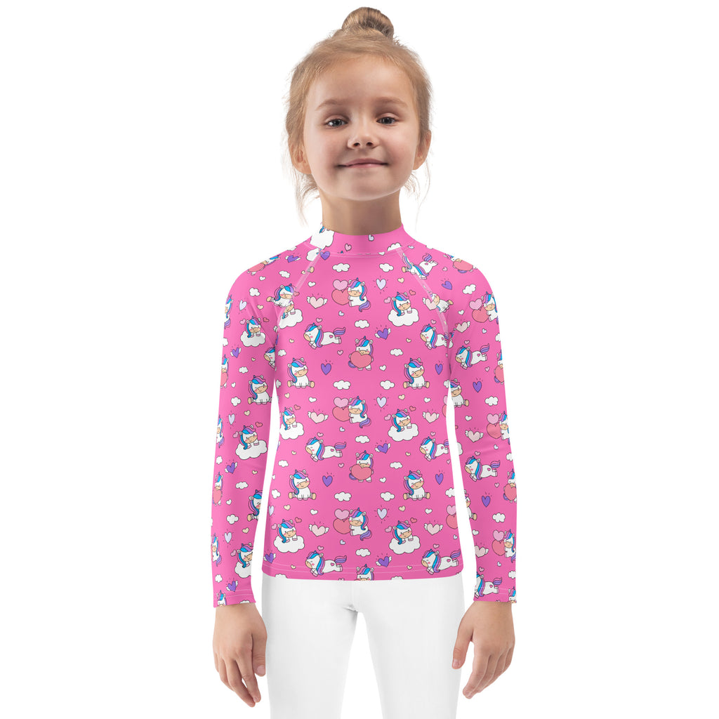 Pink long sleeve girls rash guard swim shirt with playful unicorn and cloud pattern and upf 50 plus protection