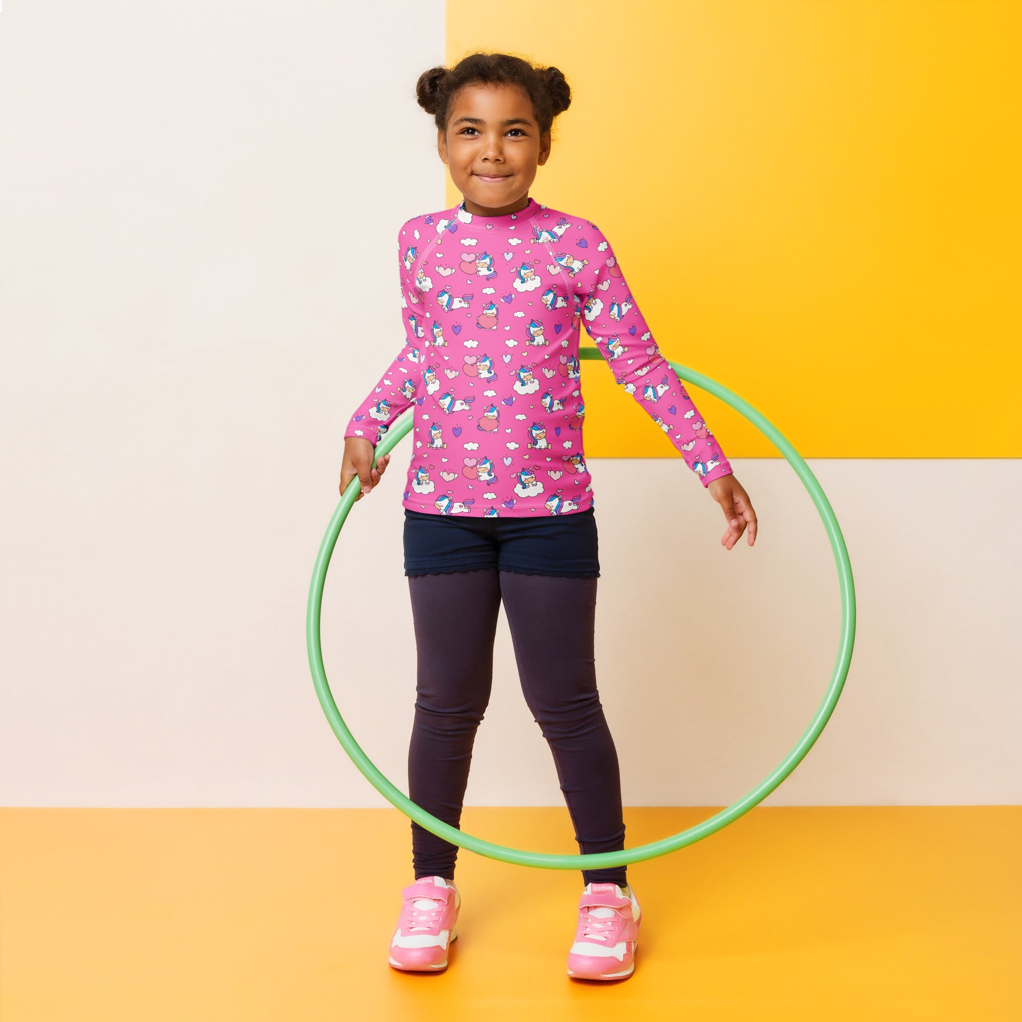 Green plastic hula hoop shown with girls unicorn hearts long sleeve rash guard swim shirt with upf 50 plus