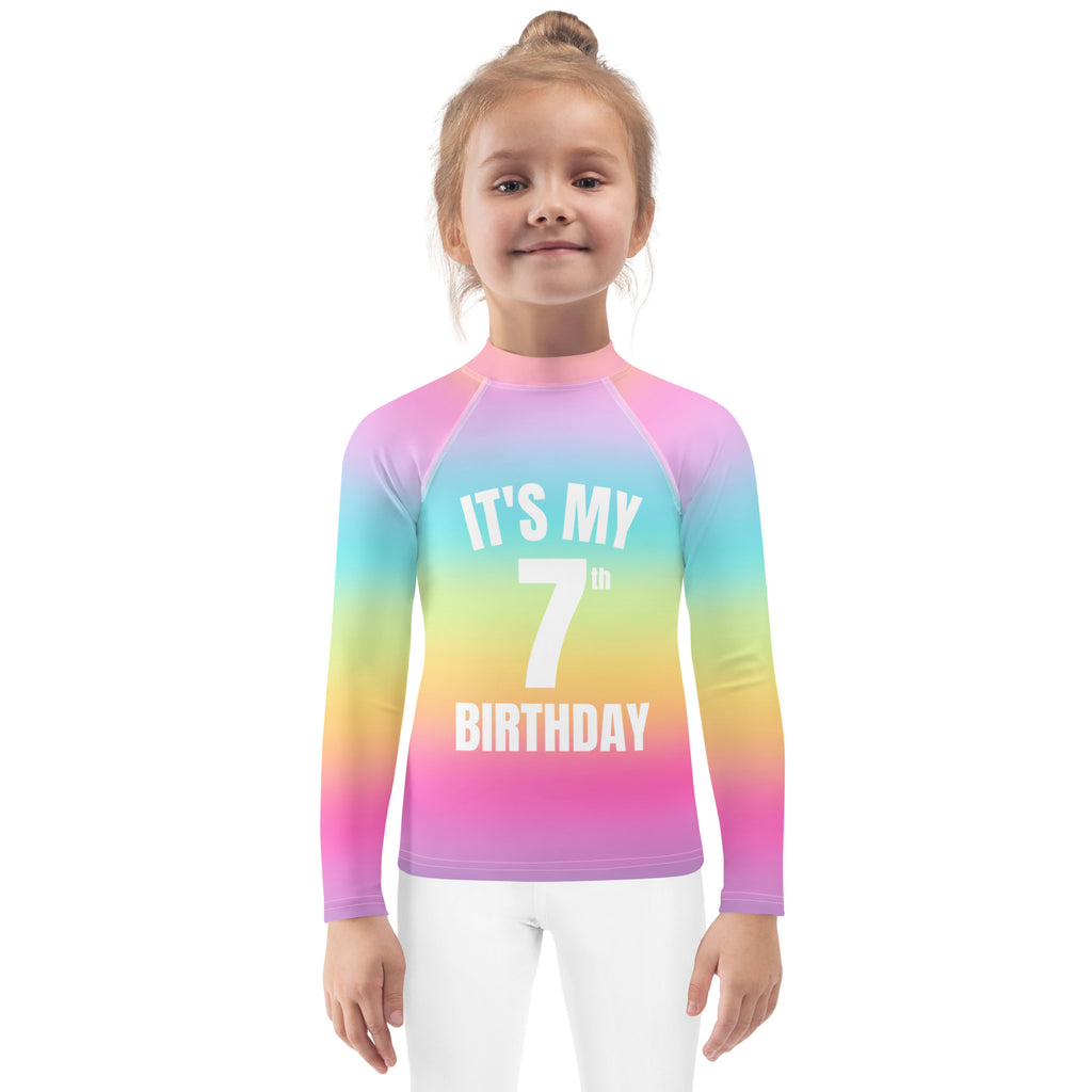 Girls bright rainbow long-sleeve rash guard with upf 50 plus and its my 7th birthday printed in white