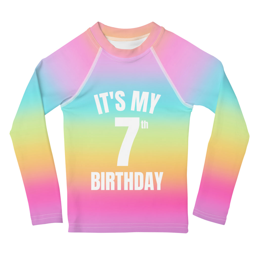 Girls bright rainbow gradient long-sleeved rash guard with white its my 7th birthday print and UPF 50+ protection